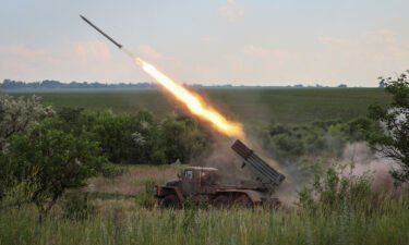 Ukrainian service members fire a BM-21 Grad multiple rocket launch system
