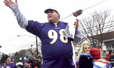 Tony Siragusa holds the trophy given to the Super Bowl winner during a parade in his hometown of Kenilworth