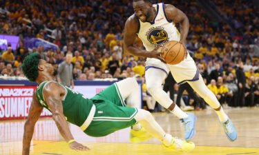 Draymond Green drives against Marcus Smart during the third quarter.