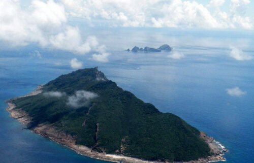 Two Chinese coast guard ships navigated Japan's territorial waters near a chain of disputed islands for more than 64 hours