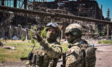 Russian servicemen guard an area of the Azovstal steel plant in Mariupol on June 13