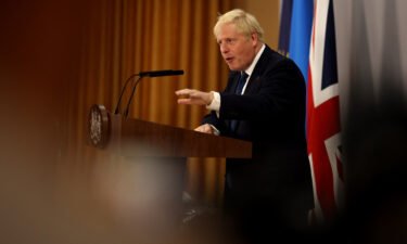 Britain's Prime Minister Boris Johnson gestures as he addresses a press conference during the Commonwealth Heads of Government Meeting (CHOGM) at Lemigo Hotel in Kigali on June 24.