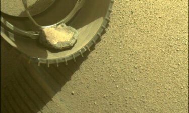 The Mars Perseverance rover gained a new traveling companion when a rock hopped into its wheel four months ago while it explored Jezero Crater.