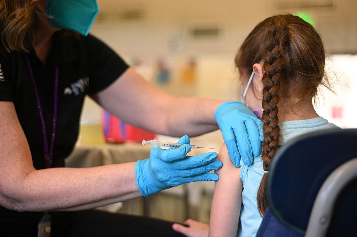 A nurse administers a pediatric dose of the Covid-19 vaccine to a girl at a L.A. Care Health Plan vaccination clinic at Los Angeles Mission College in the Sylmar neighborhood in Los Angeles, California, January 19.