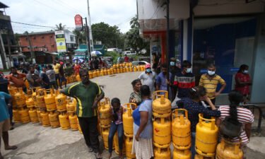 People wait to buy Liquefied Petroleum Gas (LPG) cylinders in Nawagamuwa near Colombo