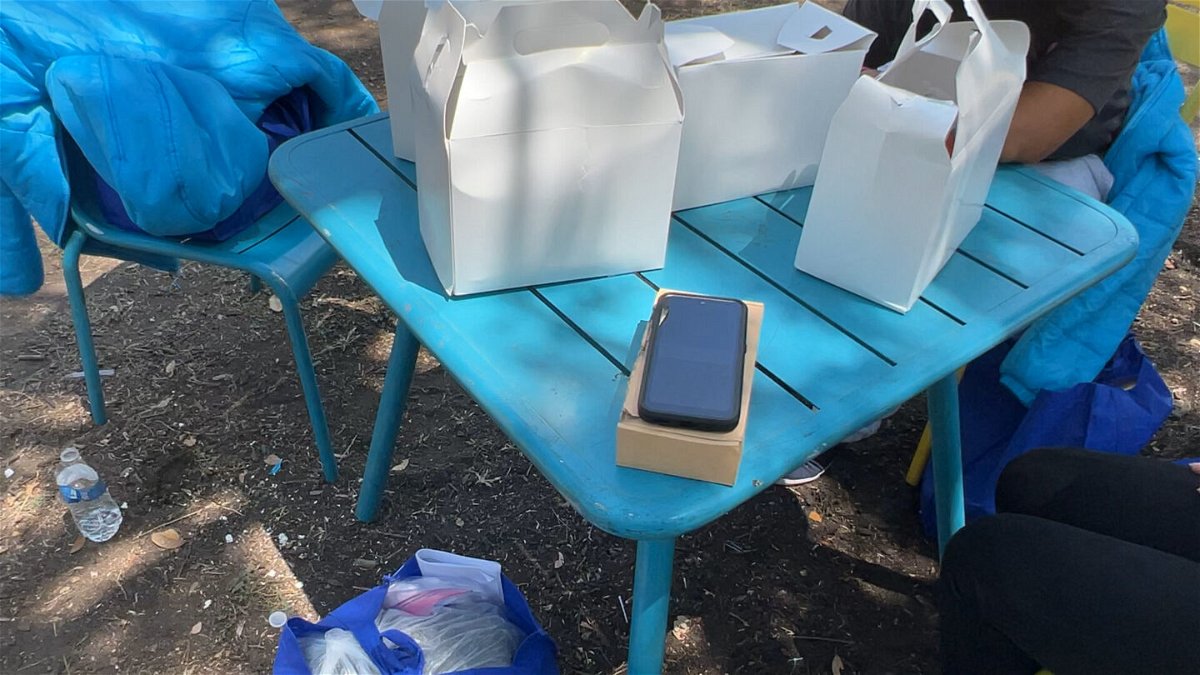 <i>CNN</i><br/>A government-issued cell phone sits on a table in a park where recently released migrants have been gathering in San Antonio