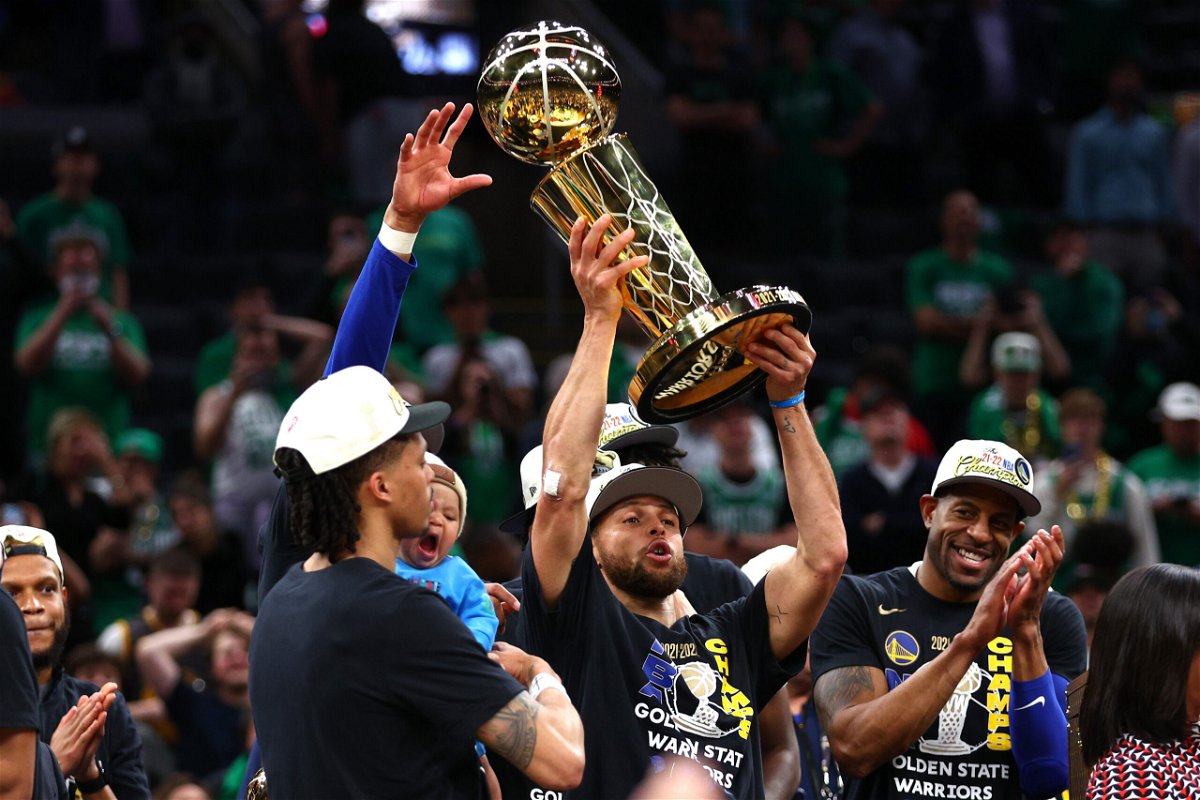 <i>Elsa/Getty Images</i><br/>Stephen Curry of the Golden State Warriors raises the Larry O'Brien Championship Trophy after defeating the Celtics in Game 6 of the 2022 NBA Finals on June 16