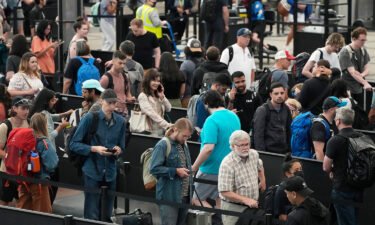 Travelers maneuver through a long line this month at a security checkpoint at Denver International Airport.