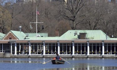 A woman rows a boat on The Lake in Central Park in front of The Loeb Boathouse in New York in March 2021. Central Park's Loeb Boathouse will permanently close this fall amid rising costs.