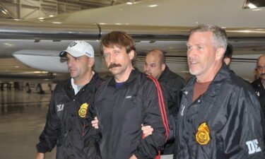 Former Soviet military officer and arms trafficking suspect Viktor Bout (center) deplanes after arriving in New York in November 2010.