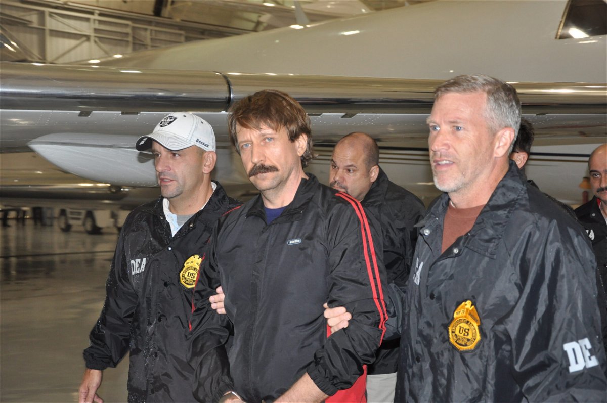 <i>US Department of Justice/Getty Images</i><br/>Former Soviet military officer and arms trafficking suspect Viktor Bout (center) deplanes after arriving in New York in November 2010.