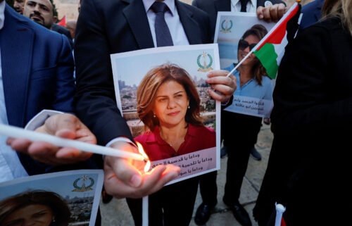 People light candles during a vigil in memory of Al Jazeera journalist Shireen Abu Akleh outside the Church of the Nativity in Bethlehem on May 16