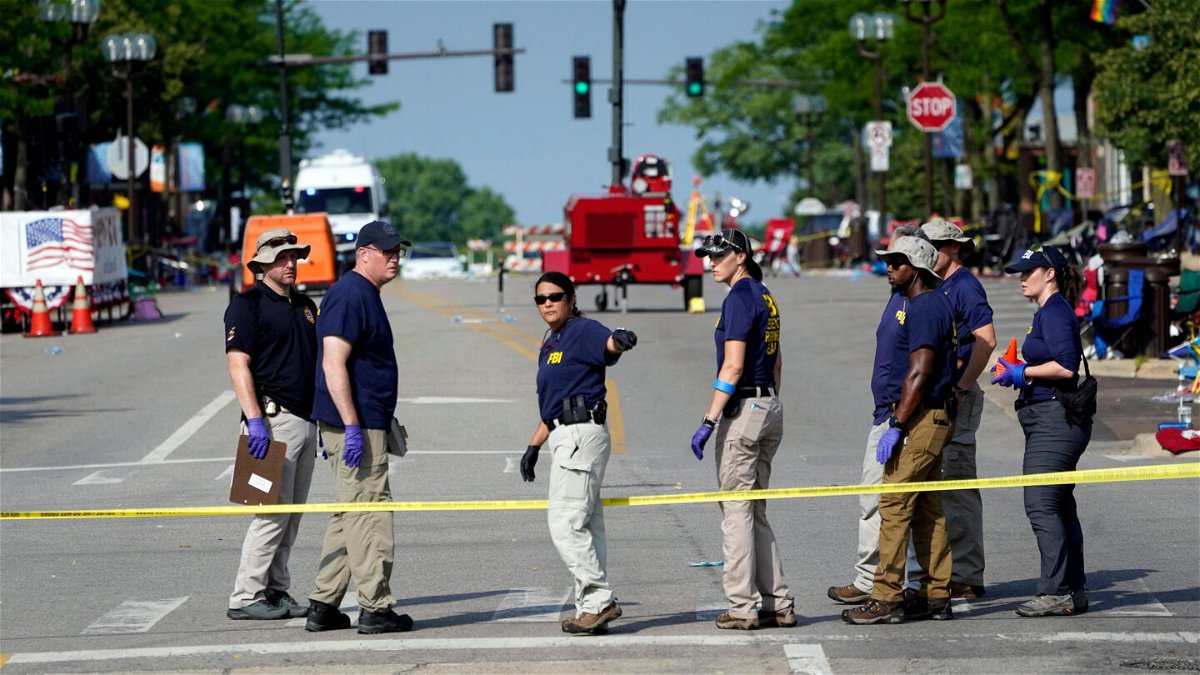 <i>Charles Rex Arbogast/AP</i><br/>Members of the FBI's evidence response team organize one day after a mass shooting in downtown Highland Park