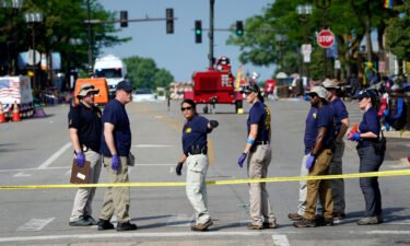 Members of the FBI's evidence response team organize one day after a mass shooting in downtown Highland Park