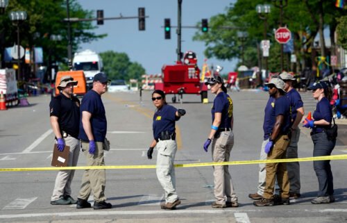 Members of the FBI's evidence response team organize one day after a mass shooting in downtown Highland Park