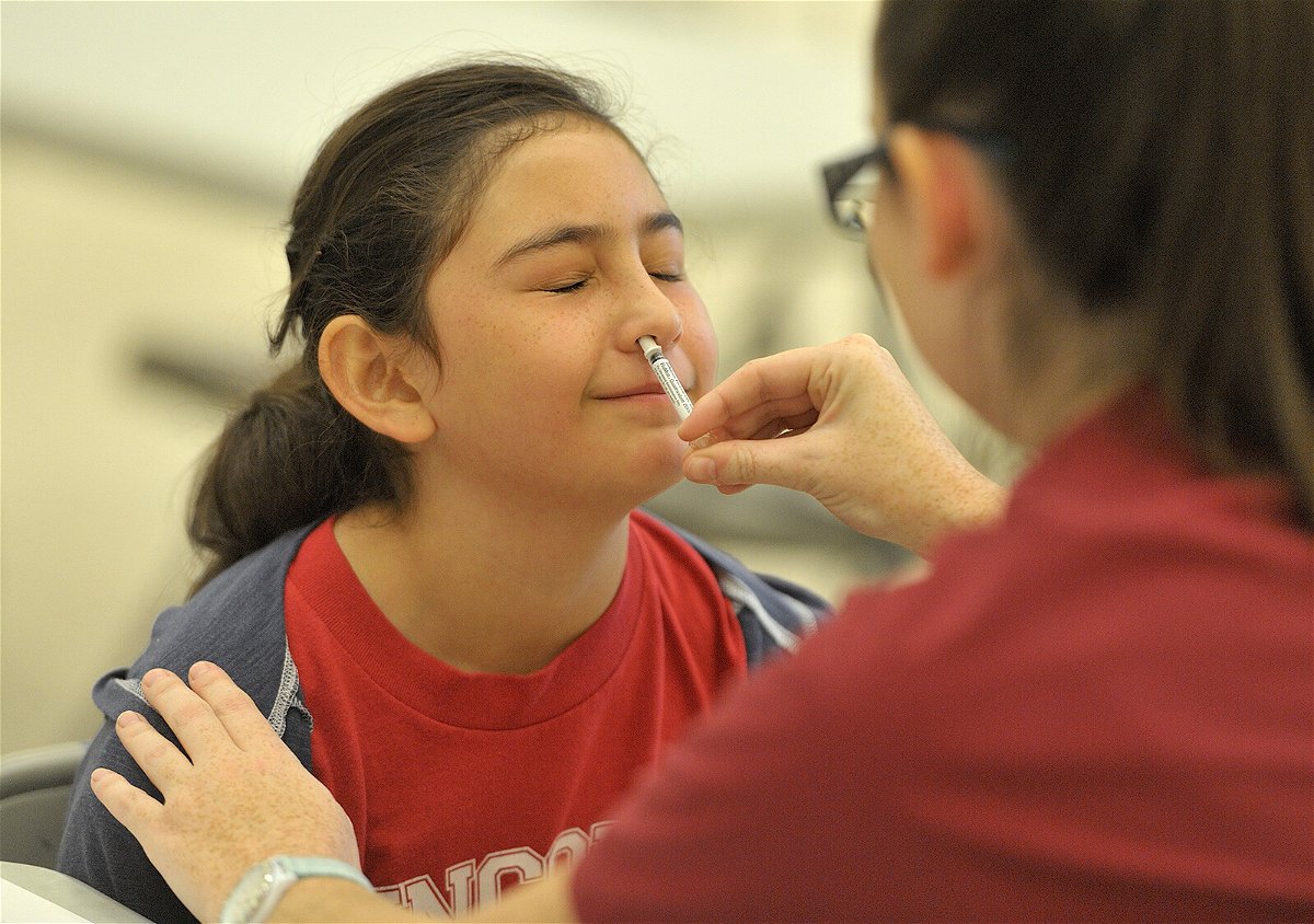 <i>Jeff Gritchen/Digital First Media/Orange County Register/Getty Images</i><br/>A student gets the FluMist vaccine