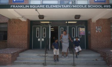 A Baltimore parent picks up her children at Franklin Square Elementary/Middle School in May