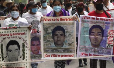 Family members and friends march seeking justice for the missing 43 Ayotzinapa students in Mexico City on August 26.