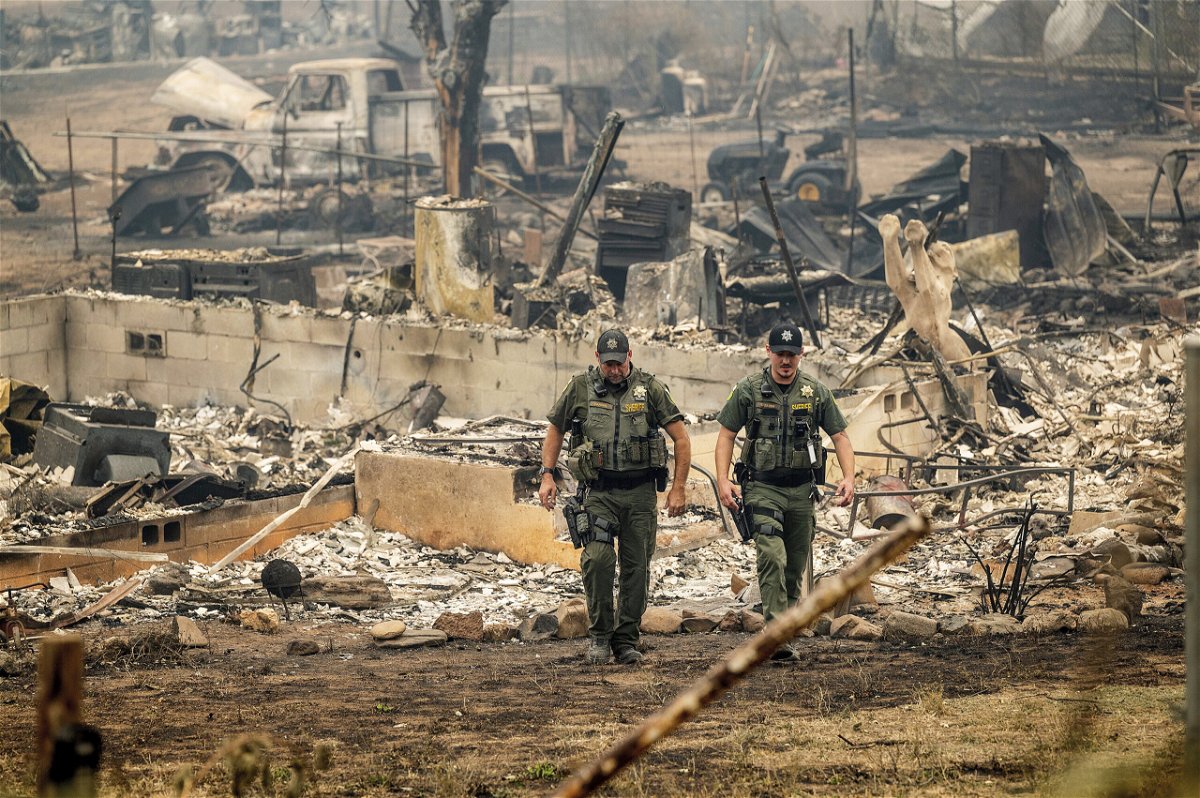 <i>Noah Berger/AP</i><br/>Officials have identified four people killed in the McKinney Fire in California as residents of the same community. Sheriff's deputies leave a home where a McKinney Fire victim was found on August 1