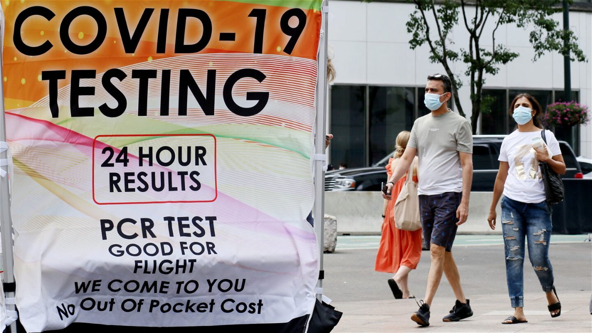 People wear masks near a COVID-19 walk-up testing site on July 6 in New York City. At the beginning of August, the CDC announced key changes to its nationwide COVID-19 guidelines.