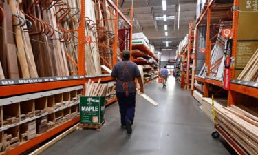 An employee works the lumber section at a Home Depot store in Alhambra