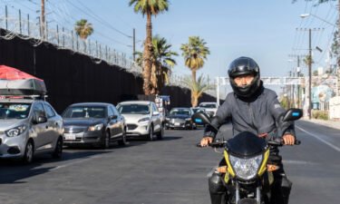 Wang Qun drives his motorcycle in Mexicali.