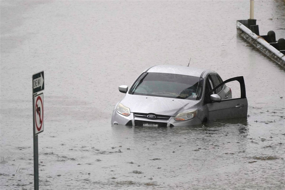 <i>LM Otero/AP</i><br/>A car sits in flood waters covering a closed highway in Dallas on August 22. More than 1