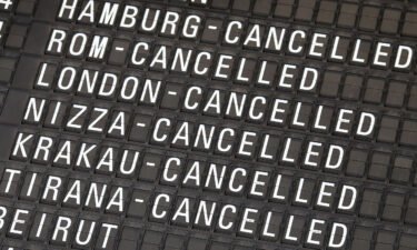 A display indicates cancelled flights at Frankfurt Airport in Frankfurt am Main