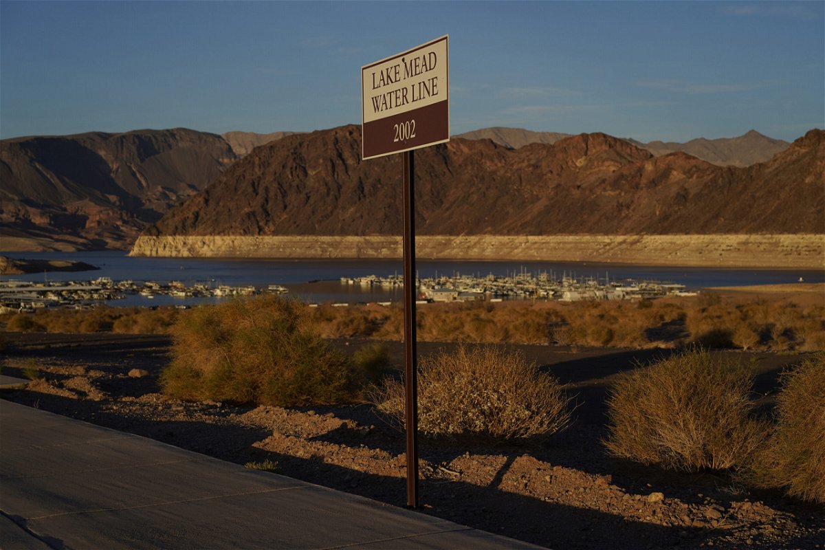 <i>John Locher/AP</i><br/>A sign marks the water line from 2002 near Lake Mead at the Lake Mead National Recreation Area on July 9