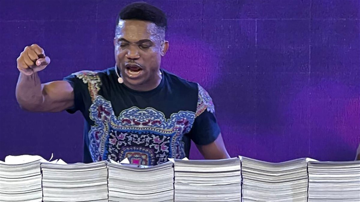 <i>courtesy Pastor Jerry Eze</i><br/>Nigerian preacher Jerry Eze prays over stacks of requests received from his followers.