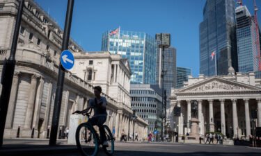 UK workers have suffered the biggest drop in their spending power in more than 20 years as prices keep soaring. A cyclist rides past in London on August 11.