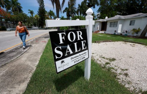 Home sales declined for the sixth month in a row in July as higher mortgage rates and prices push prospective buyers out of the market. A 'for sale' sign hangs in front of a home on June 21 in Miami.