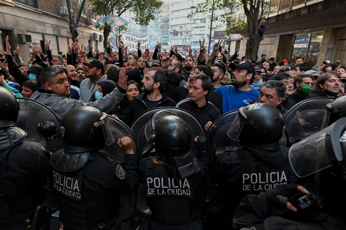 <i>Luis Robayo/AFP/Getty Images</i><br/>Supporters of Argentina's Vice President Cristina Fernandez de Kirchner clash with riot police during a demonstration near her home in Buenos Aires