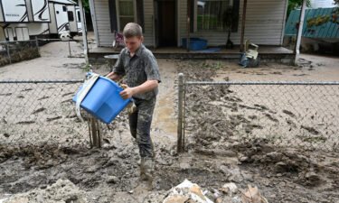 Members of the local Mennonite community remove mud filled debris from homes following flooding at Ogden Hollar in Hindman