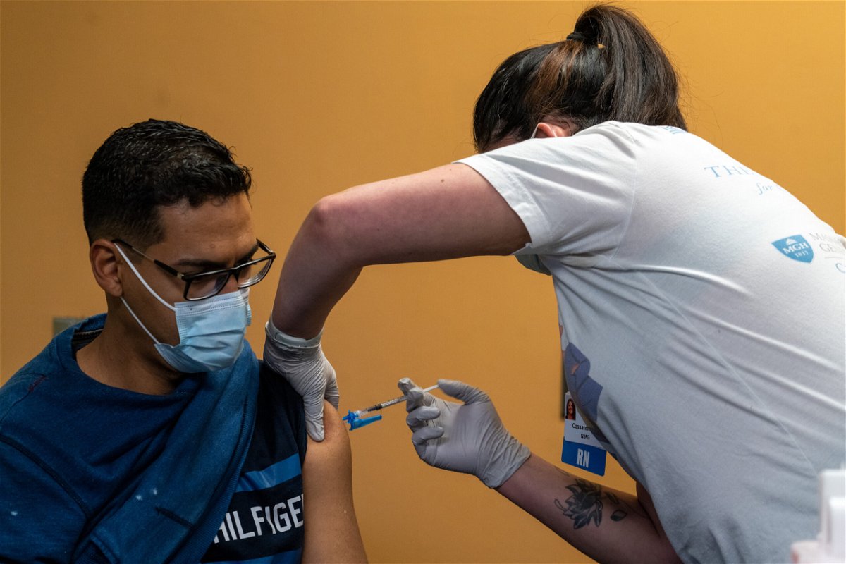 <i>Vanessa Leroy/Bloomberg/Getty Images</i><br/>A healthcare worker administers a dose of the Pfizer-BioNTech Covid-19 vaccine in Peabody
