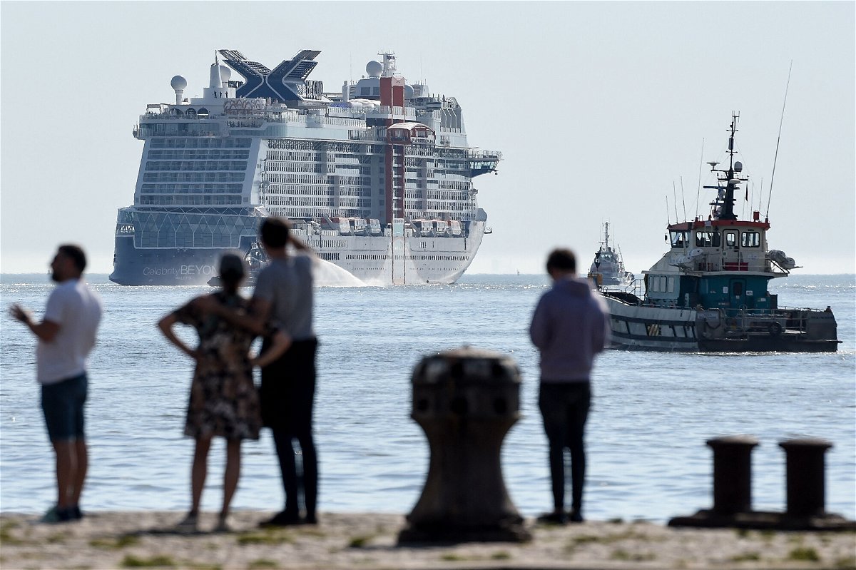 <i>Sebastien Salom-Gomis/AFP/Getty Images</i><br/>Pedestrians look at the Royal Caribbean (RCCL) cruise ship Celebrity Beyond as it leaves Les chantiers de l'Atlantique shipyards