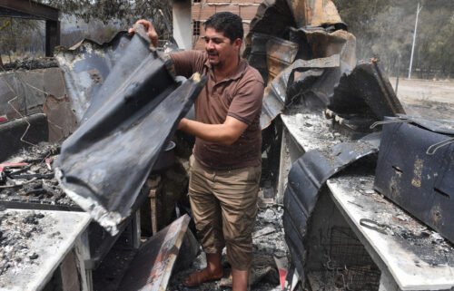 At least 26 people have been killed and several injured in wildfires that ravaged mountainous areas in the east of Algeria. A man checks burnt objects following raging fires in Algeria's city of el-Kala on August 17.