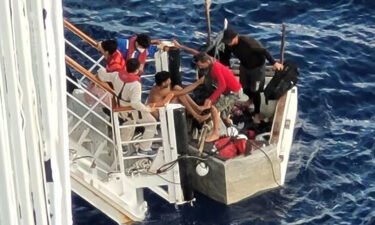 A video captured Cuban migrants in a makeshift raft being rescued by a Carnival Cruise liner. The migrants are seen here boarding the Carnival Paradise cruise ship.