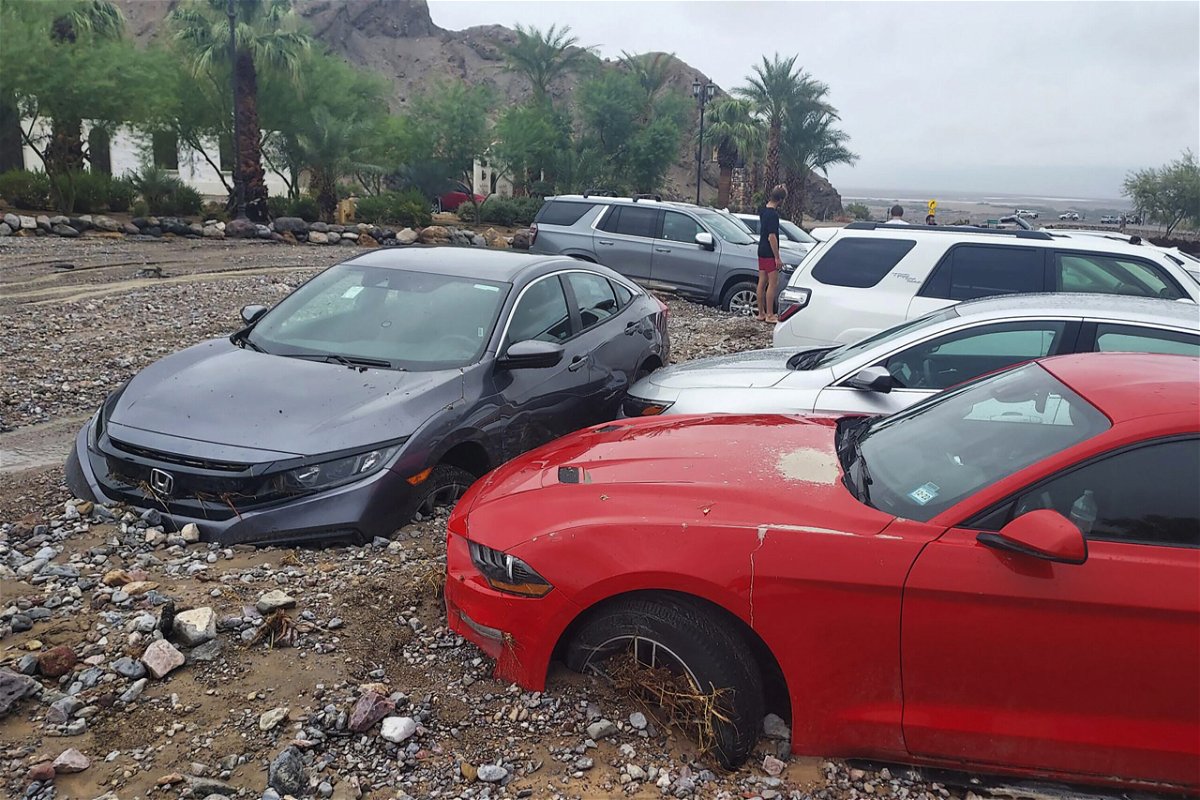 <i>National Park Service/AP</i><br/>Cars are seen stuck in mud and debris at The Inn at Death Valley on August 5.