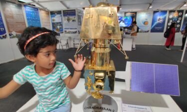 A child touches a model of Indian mission to the moon.