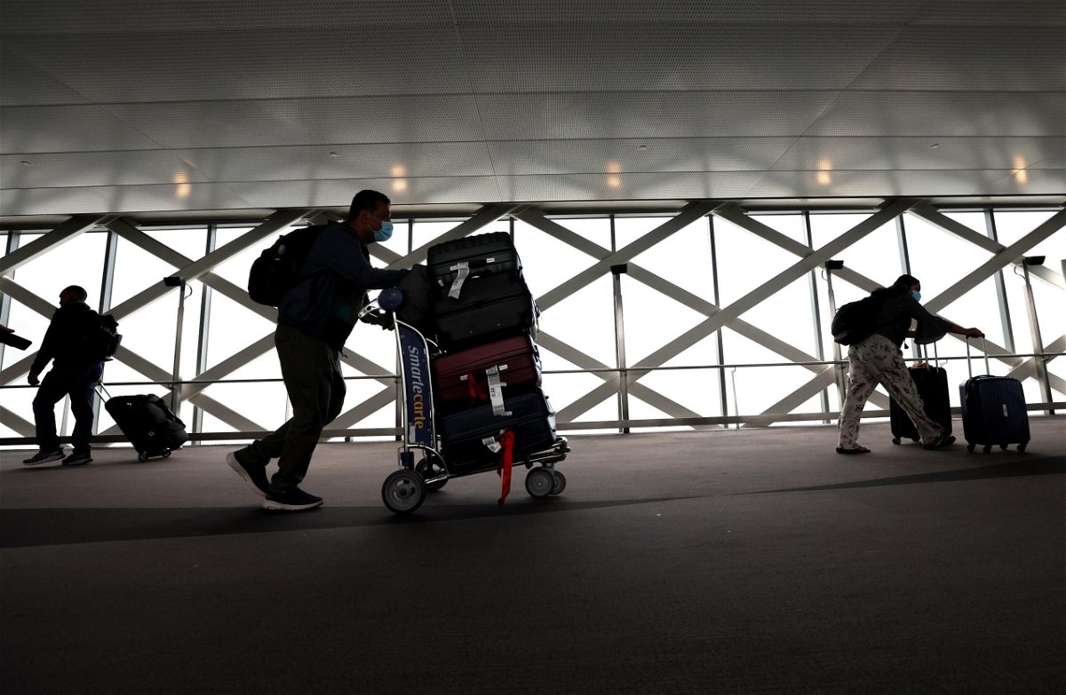 <i>Justin Sullivan/Getty Images</i><br/>Travelers walk with their luggage at San Francisco International Airport on July 01