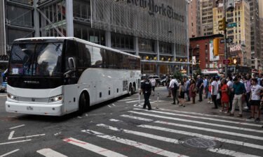 A bus carrying migrants from Texas arrives at Port Authority Bus Terminal on August 10 in New York.