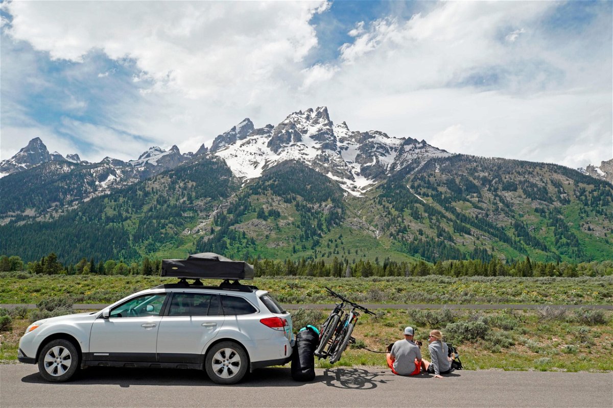 <i>George Frey/Getty Images</i><br/>A couple parks on the side of the road to have lunch in Grand Teton National Park in June 2020 outside Jackson