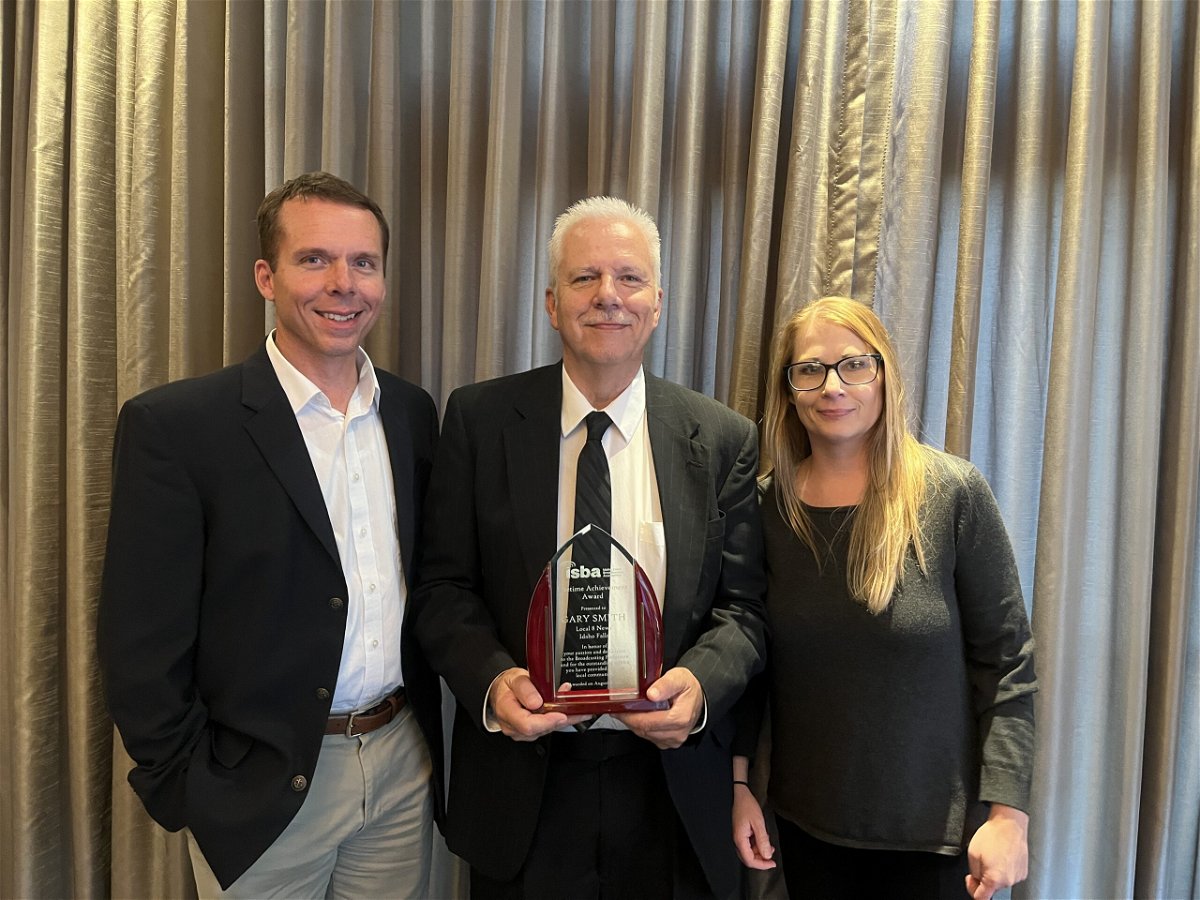 Gary Smith (center) is given the Lifetime Achievement Award from the Idaho State Broadcasters Association on Aug. 6, 2022.  