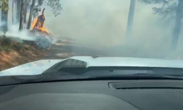 Video shows the deputy had to go through a dirt road with heavy smoke and flames in some areas.