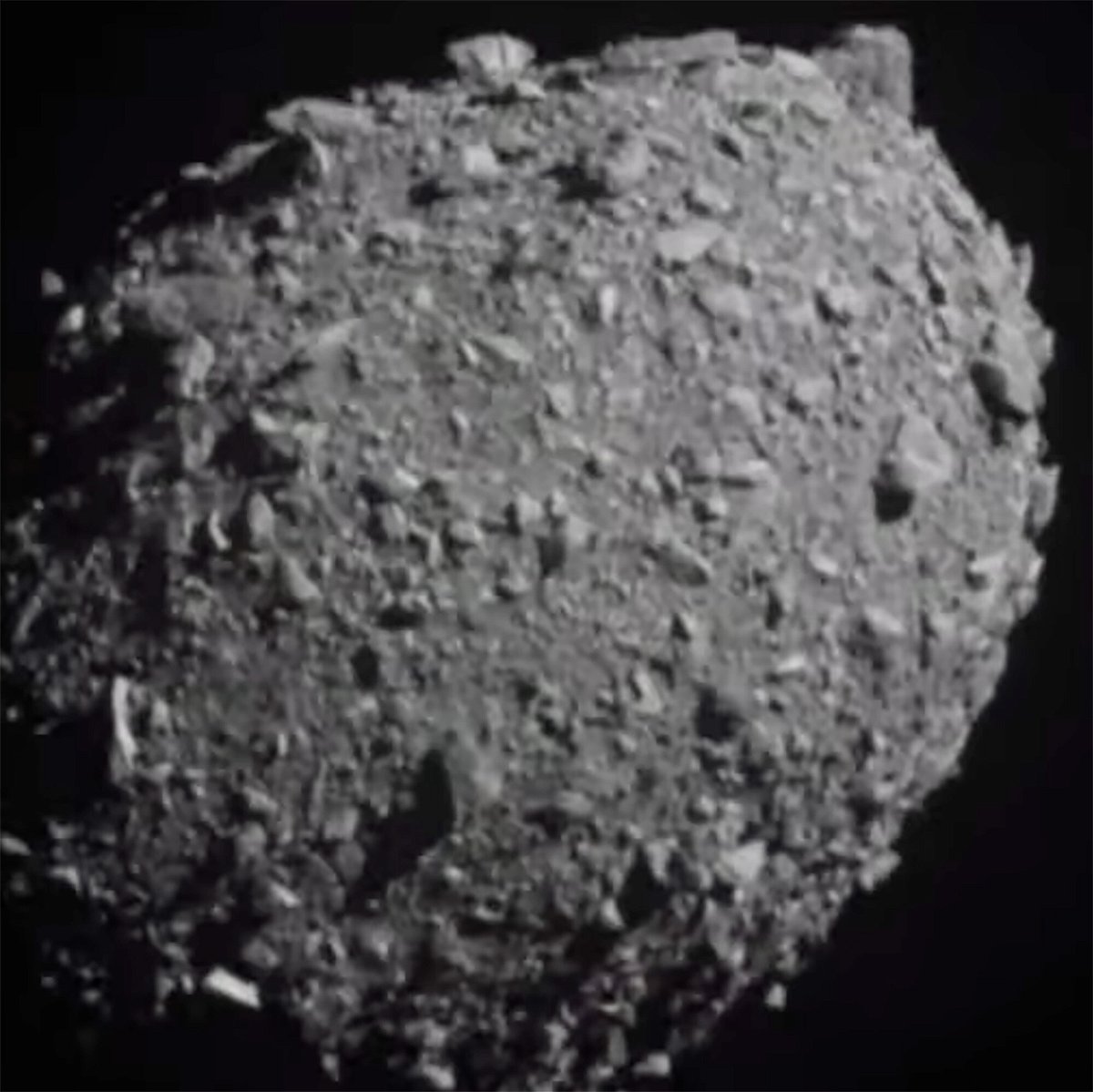 <i>NASA</i><br/>A detailed view of Dimorphos can be seen seconds before the DART spacecraft hit the asteroid.