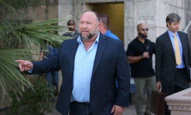 Alex Jones steps outside of the Travis County Courthouse