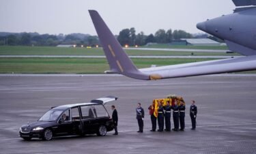 Pallbearers from the Queen's Colour Squadron (63 Squadron RAF Regiment) leave having carried the coffin of Queen Elizabeth II to the Royal Hearse having removed it from the C-17 at the Royal Air Force Northolt airbase on September 13.