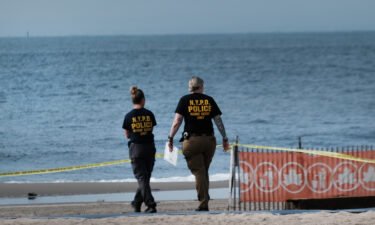 Police are seen here working along a stretch of beach at Coney Island