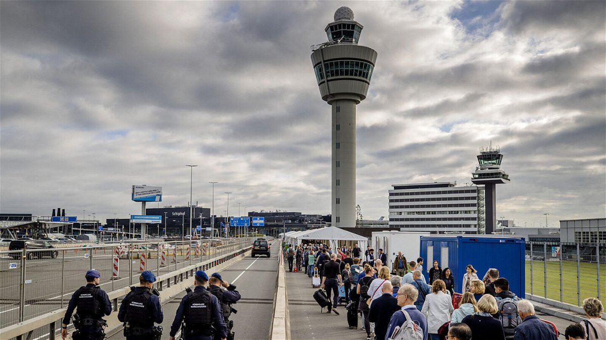 <i>Sem Van Der Wal/AFP/Getty Images</i><br/>Travelers queue outside Schiphol airport
